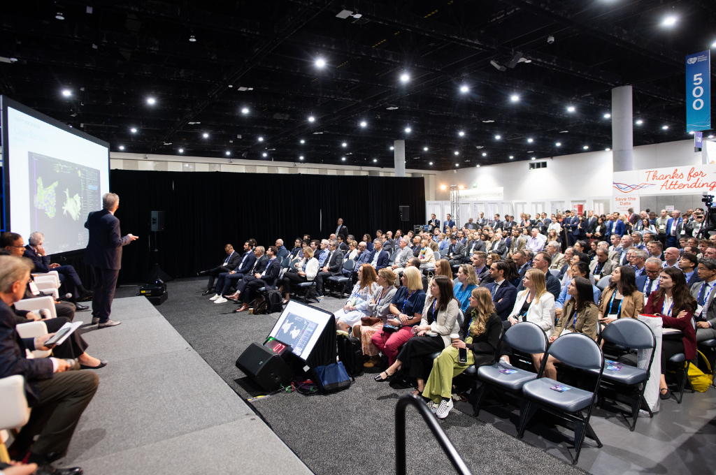 A large audience attends a Rhythm Theater presentation during Heart Rhythm 2025 in a large Exhibit Hall