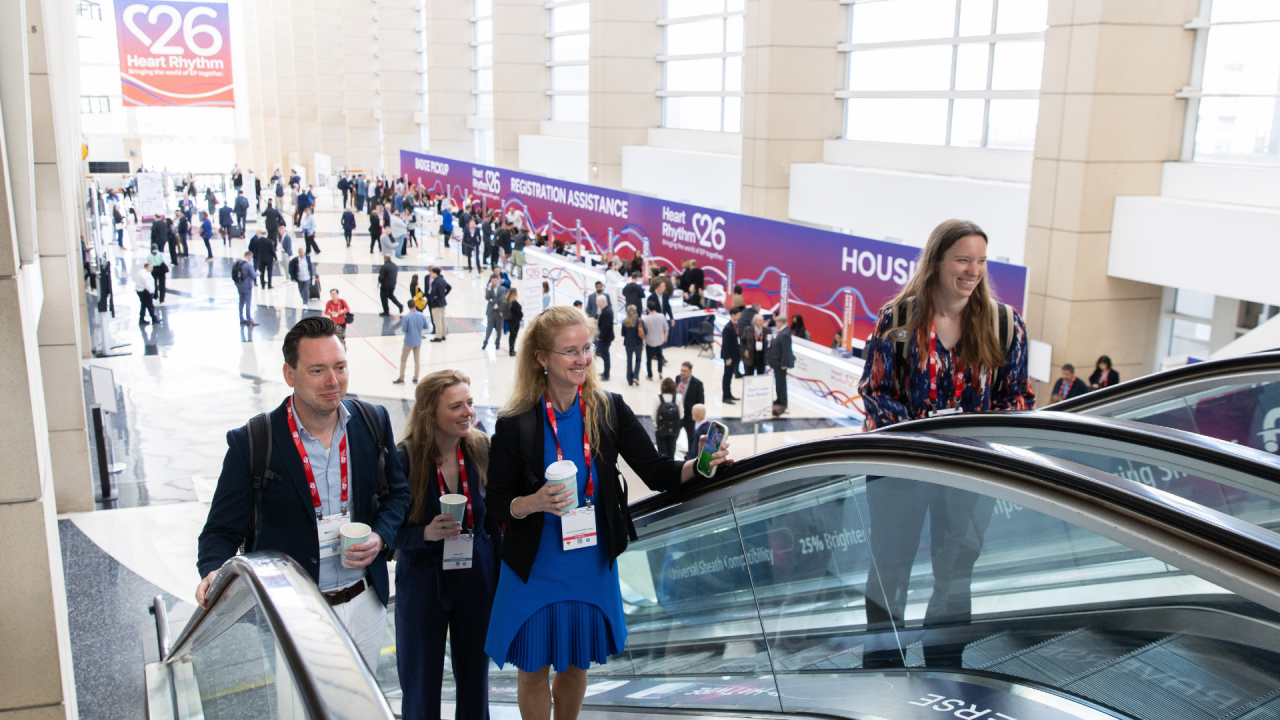 Attendees riding the escalator in the registration hall at Heart Rhythm 2026 in Chicago